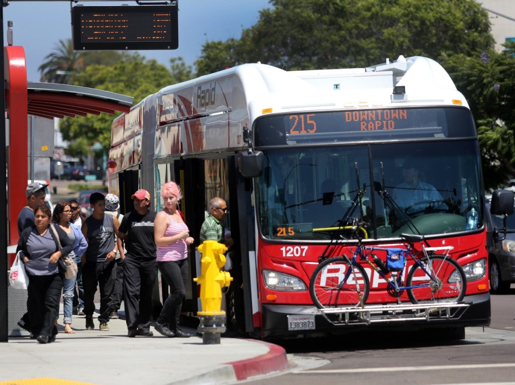 July 15, 2015. San Diego, CA. USA| Mid-City Rapid 215 bus on El Cajon Boulevard at the 43rd St. intersection by the YMCA |Photos by Jamie Scott Lytle.Copyright.