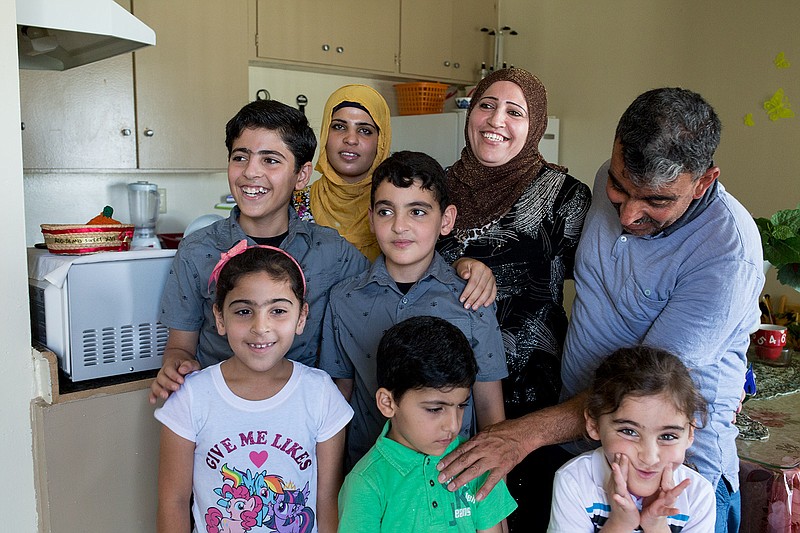 a refugee family in the kitchen of their El Cajon apartment
