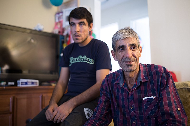 Mahmoud Alibrahim with his son in their El Cajon apartment