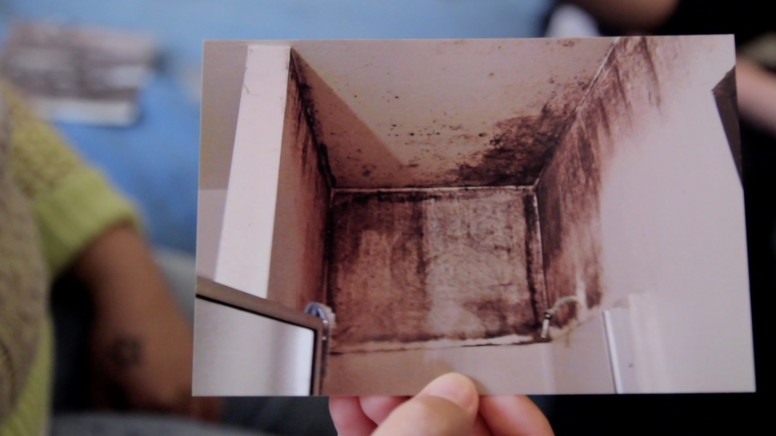 Karina Villanueva, a onetime tenant of Bankim Shah, shows a photo of mold above her shower