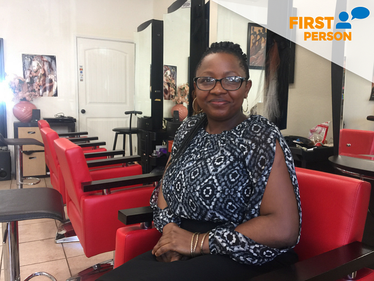 Queentabel Banka sits in her hair braiding salon in San Diego's City Heights neighborhood.