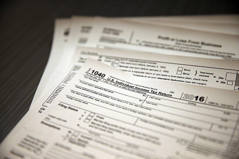 Tax forms sit on a desk at the start of the tax season rush.